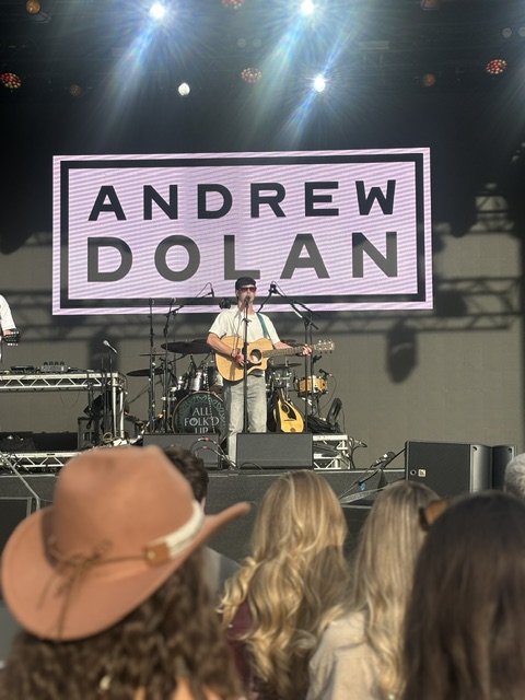 Andrew Dolan performing on an outdoor festival stage